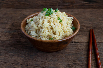 Organic Brown Rice in the bowl on the wooden table