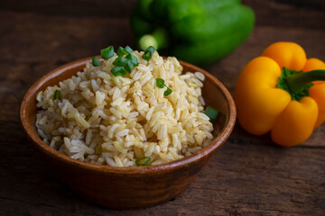 Organic Brown Rice in the bowl on the wooden table
