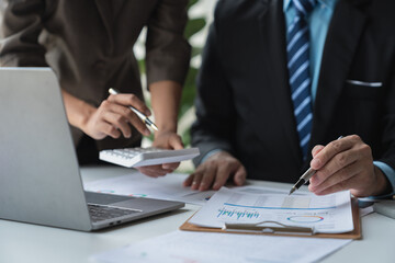 Business team working at office with laptop and calculator to calculate graph data sheet. Numerical charts that display financial budgets, investments, project plans, joint operations.