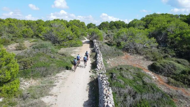 Drone flys over gravel cyclists in Menorca event through European summer.