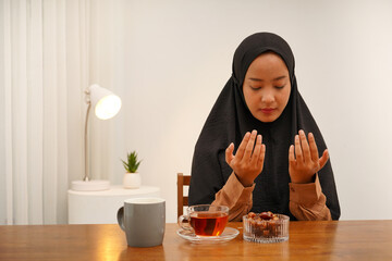 Photo of Asian Muslim woman waking up early to have a morning breakfast on fasting month. Asian...
