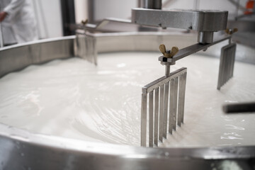 Tank full of milk in a cheese factory. Parmesan cheese production in Italy. The concept of modern...