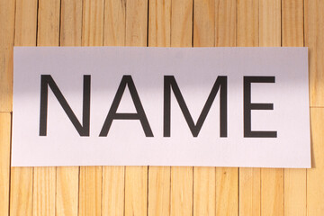 the word name on a wooden background , brand and naming concept