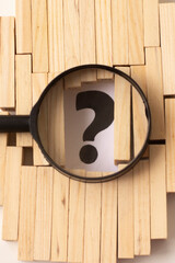 a question mark among the wooden blocks.