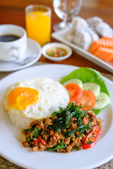 Stir Fried Basil with Pork and a fried egg on the table