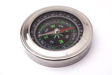 Magnetic silver metal compass on white background