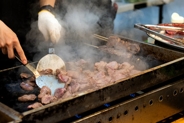 The chef is stir-frying the beef.