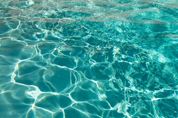 defocused turquoise ripple water blured background. photo of defocused turquoise water
