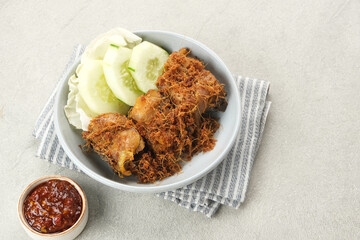 Ayam Goreng Lengkuas, fried chicken cooked with spices and sprinkled with grated galangal. Indonesian traditional food.  
