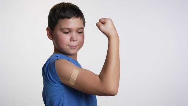 A boy with a patch on his shoulder. Vaccination concept