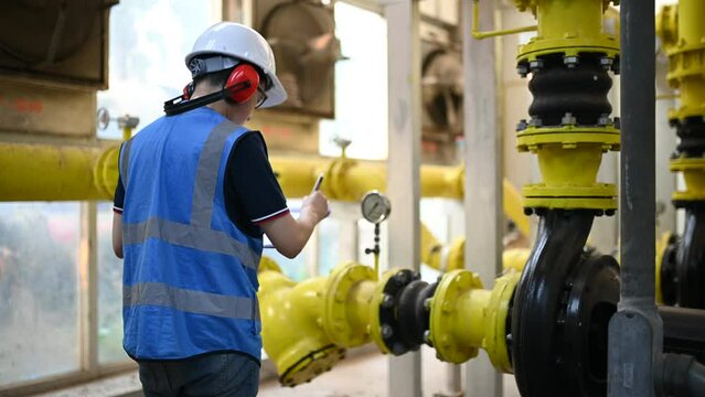Maintenance technician at a heating plant,Petrochemical workers supervise the operation of gas and oil pipelines in the factory,Engineers put hearing protector At room with many pipes