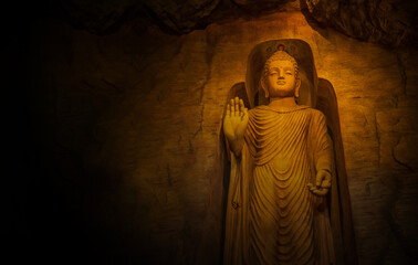 Statue of Buddha standing in meditation with copy space for text or can use for background.
