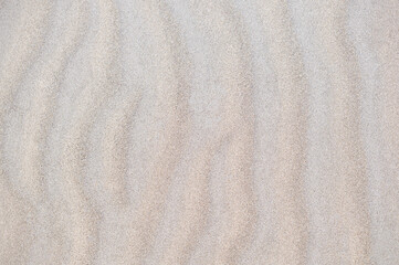 Fototapeta na wymiar Fine beach sand in the summer sun, pattern, background