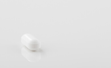 Pharmacy theme, white pill on a glossy surface