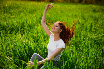 Naklejka na ściany i meble playful, happy, free woman sitting in tall grass