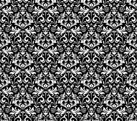 Wallpaper in the style of Baroque. Seamless vector background. White and black floral ornament. Graphic pattern for fabric, wallpaper, packaging. Ornate Damask flower ornament