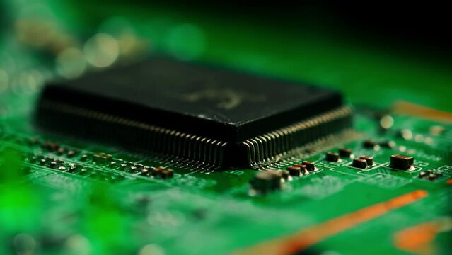 Green printed circuit motherboard components microchips CPU processor transistors semiconductors close-up 