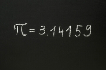 Number Pi written in chalk on a blackboard
