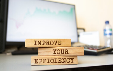 Wooden blocks with words 'IMPROVE YOUR EFFICIENCY'. Business concept