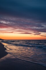 Beautiful colorful landscape on the beach by the sea. Sunrise over the Baltic Sea in Jastarnia, Poland.