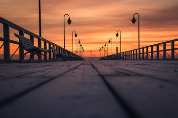 Beautiful sunrise over the Polish sea. Popular pier on the Baltic Sea at sunrise. Shallow depth of field photo with foreground blur effect.
