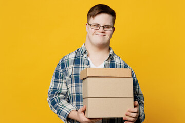 Young man with down syndrome wears glasses casual clothes hold cake dessert in unmarked empty blank...