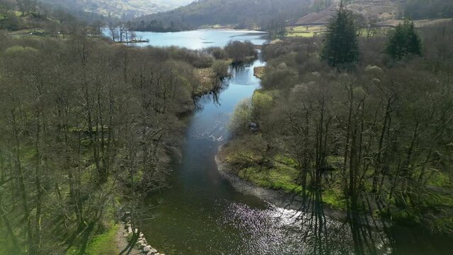 River Rothay in sunshine flowing into Rydal Water in the English Lake District Cumbria