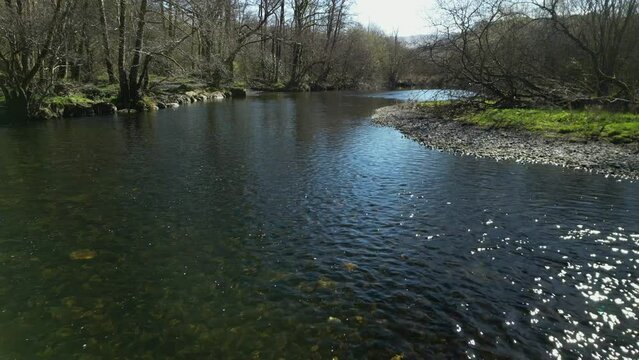 Slow motion flying low up River Rothay near Rydal Water in the English Lake District Cumbria