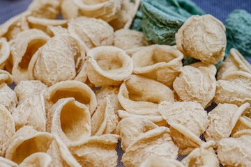 Fototapeta na wymiar Fresh orecchiette or orecchietta, made with durum wheat and water, handmade pasta typical of Puglia or Apulia, a region of Southern Italy, close up