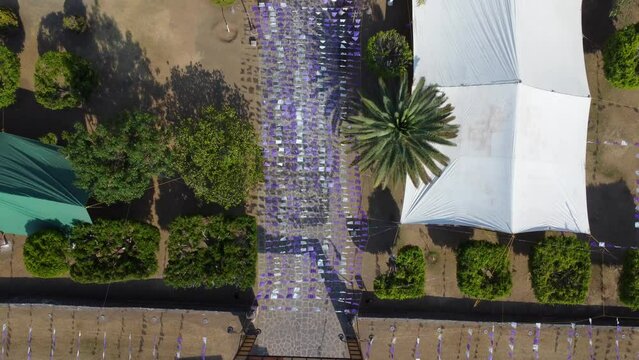 overhead aerial shot of mexican church in jacaranda season
