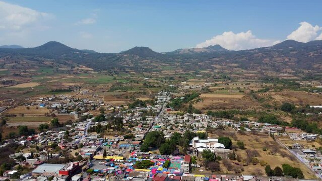 aerial view of a mexican town with mountains in the background