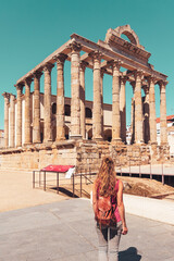 Woman holiday maker admiring the roman temple of Diana in Merida, Spain- Extremadura - obrazy, fototapety, plakaty