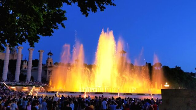 Magic singing fountains of Montjuic, people watch the performance that takes place several times a week. Barcelona, Spain