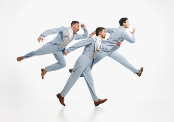 Serious men wearing elegant suit hurry up over white background. Going on important business