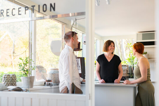 Guests talking with hotel receptionist
