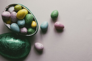  A green Easter egg filled with green, blue, yellow and pink Easter caramels