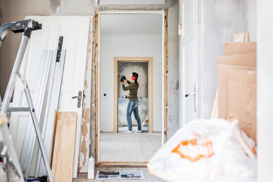 Woman polishing door frame during renovation