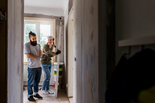 Couple laughing during renovation