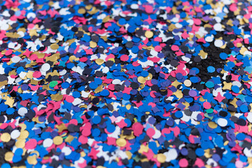 Colorful confetti (paper pieces) covering the pavement thrown by cheering carnival people during the Basel carnival, Switzerland.