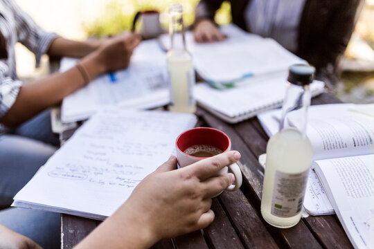 Students learning at cafe outside library during study session.