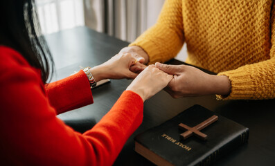 Obraz premium Christians are congregants join hands to pray and seek the blessings of God, the Holy Bible.Study the Word of God
