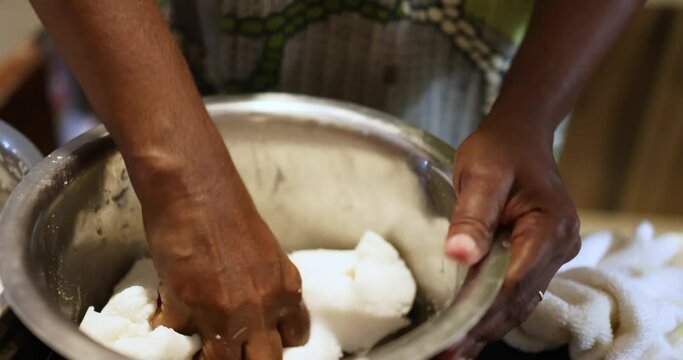The close-up of hands. A woman is preparing the dough for Rice idlis