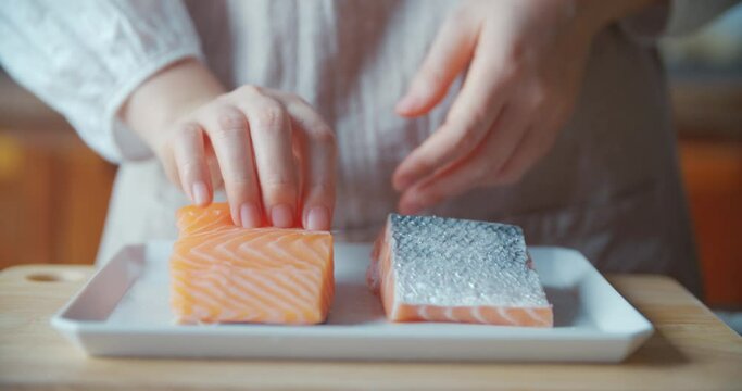 Placing Raw Salmon on White Rectangle Plate