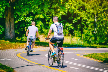 Cyclists ride on the bike path in the city Park
