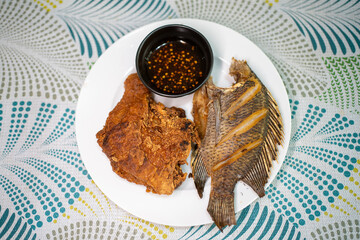 fried chicken and fish on a plate 