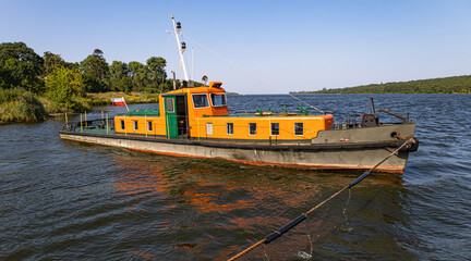Fototapeta premium Small tugboat, ferry crossing between Mikoszewo and Sobieszewo
