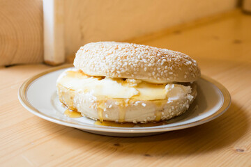 Delicious cream cheese sandwich on bagel bread. A bagel is a bread traditionally made from wheat flour and usually has a hole in the center.
