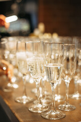 Fototapeta premium lots of champagne glasses on the wooden bar counter