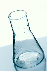 Empty glass medical flask stands on table. Concept conducting experiments, experiments and laboratory tests. Background..
