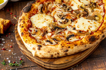 Cheese and mushroom pizza with toppings on the cutting board
